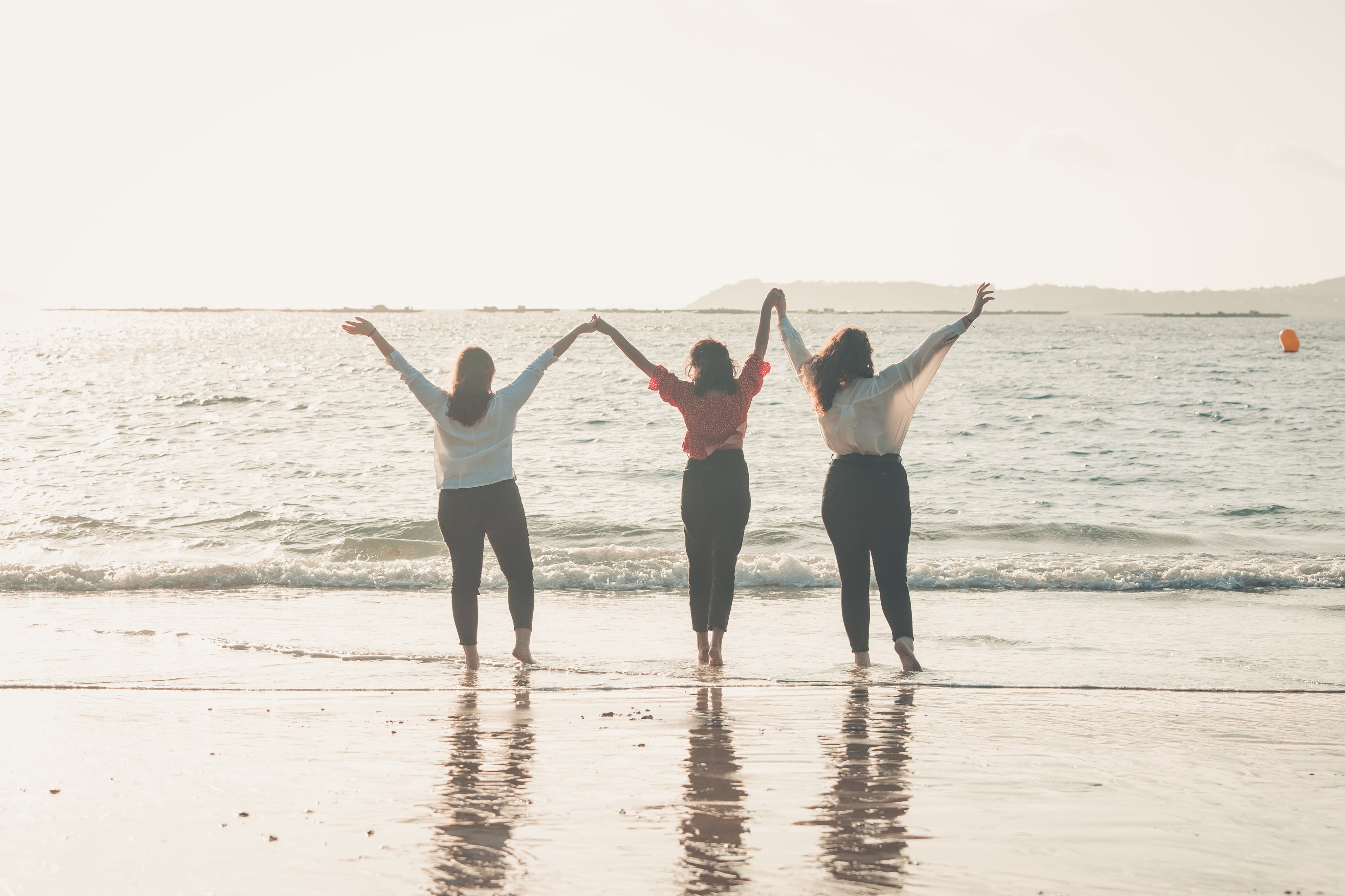 files/three-people-hold-hands-with-their-arms-to-the-sky.jpg